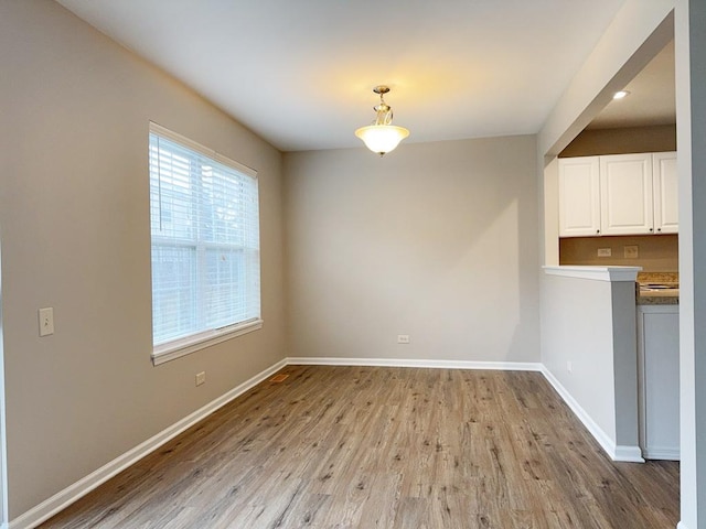 unfurnished dining area with light hardwood / wood-style flooring