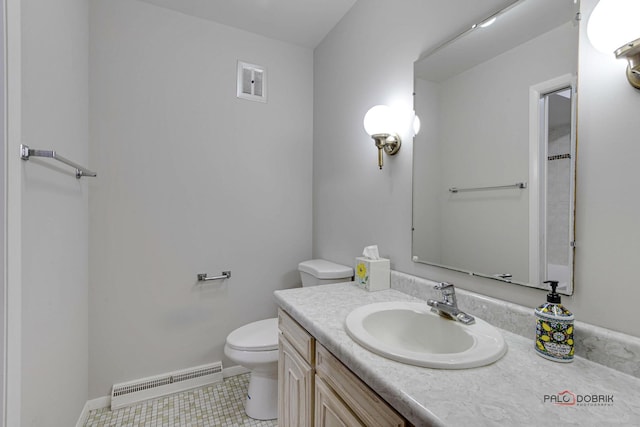 bathroom featuring tile patterned floors, vanity, and toilet