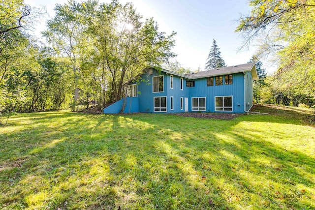 rear view of house with a yard