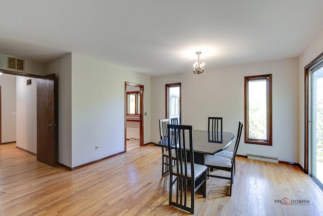 dining room featuring light hardwood / wood-style flooring, an inviting chandelier, and baseboard heating