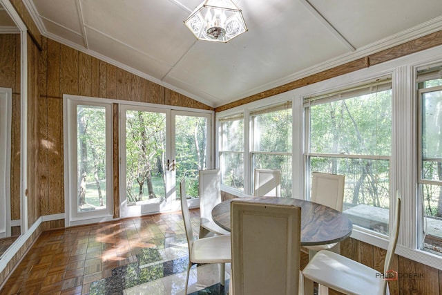 sunroom featuring vaulted ceiling and an inviting chandelier