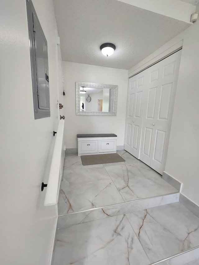 bathroom featuring a textured ceiling and electric panel