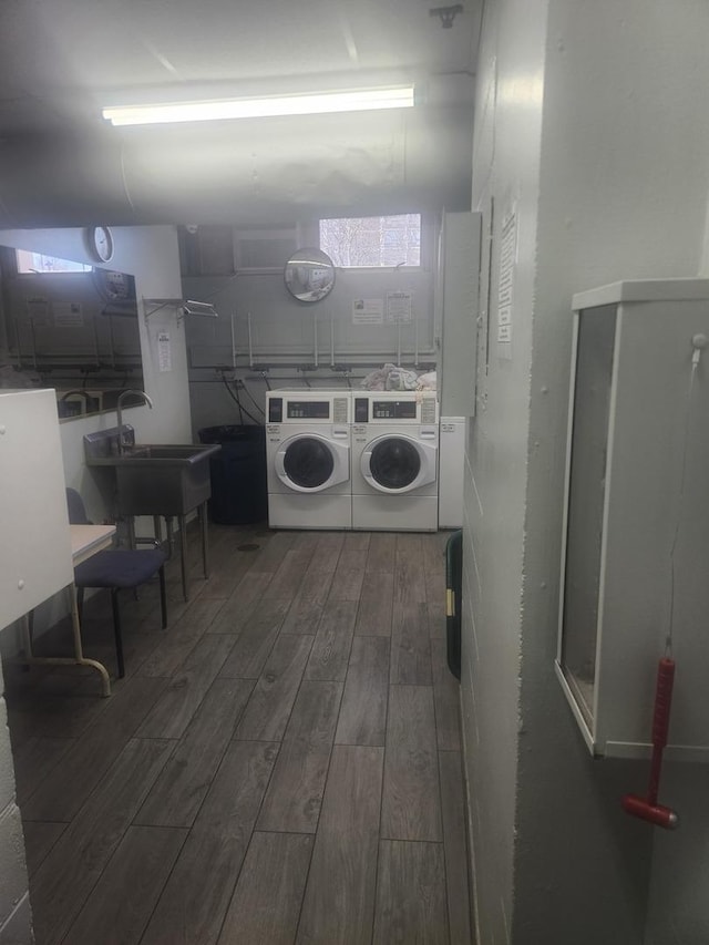 laundry room with independent washer and dryer, dark hardwood / wood-style flooring, and sink