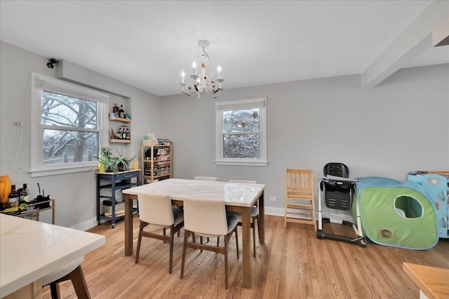 dining space featuring a chandelier, light hardwood / wood-style floors, and a healthy amount of sunlight