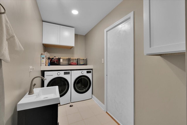 laundry room featuring cabinets, independent washer and dryer, and light tile patterned floors