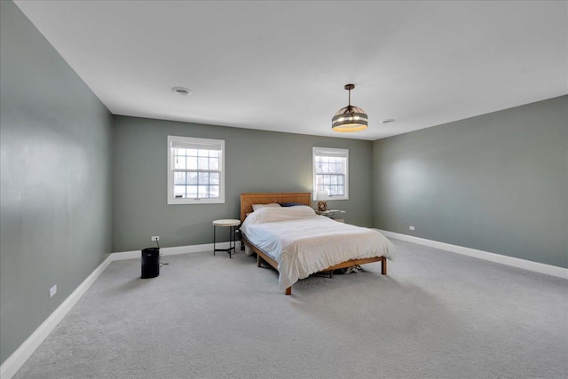 carpeted bedroom featuring multiple windows