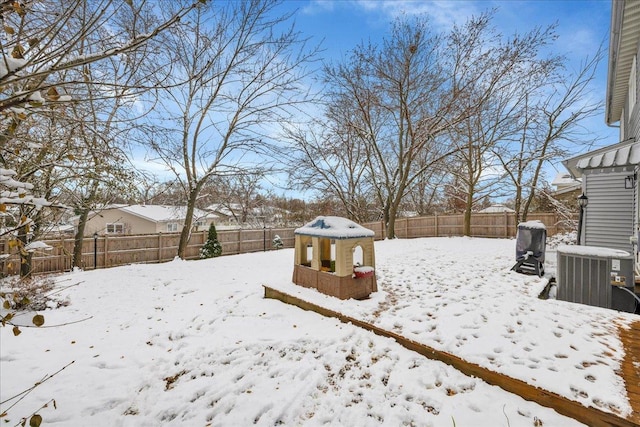 snowy yard featuring cooling unit