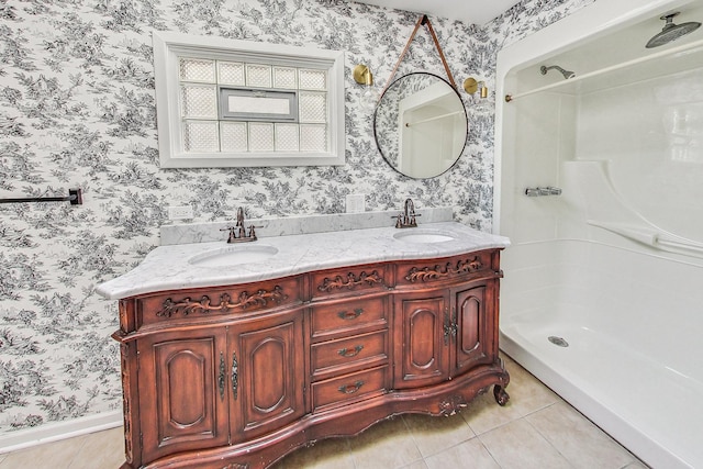 full bath featuring a stall shower, tile patterned flooring, a sink, and wallpapered walls