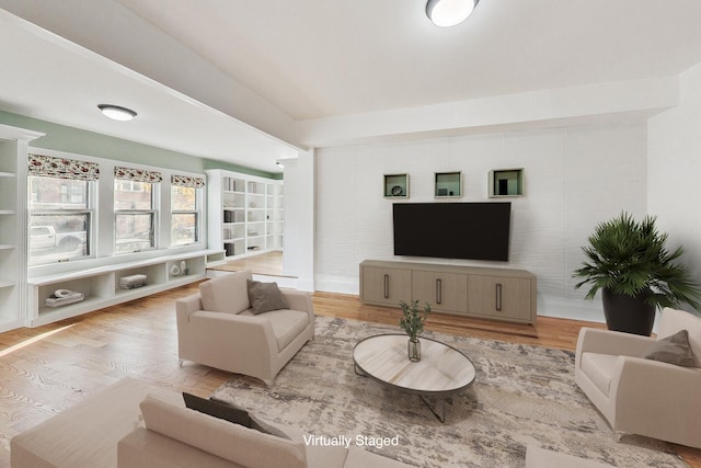 living area with wood finished floors and baseboards