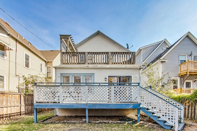 back of house with stairway, fence, and a balcony