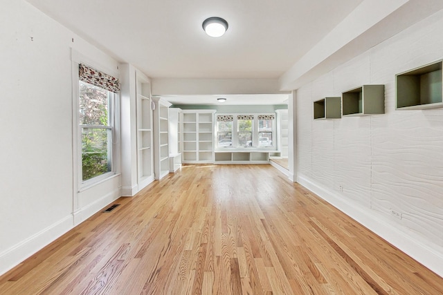 unfurnished sunroom with a wealth of natural light and visible vents