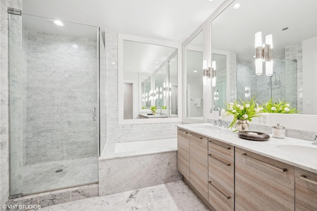 bathroom featuring a garden tub, a sink, and a marble finish shower