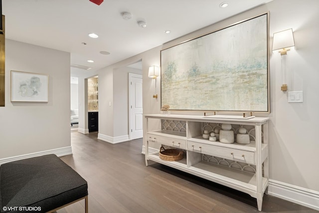 hall with baseboards, wood finished floors, and recessed lighting