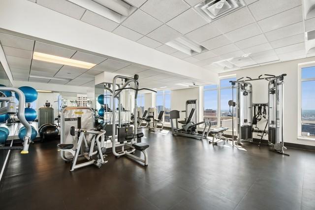 workout area featuring visible vents and a drop ceiling