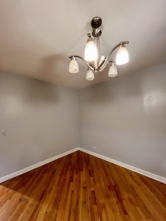 7628 S Essex Ave Unit 1N, Chicago, IL 60649 - spare room featuring a chandelier and wood finished floors