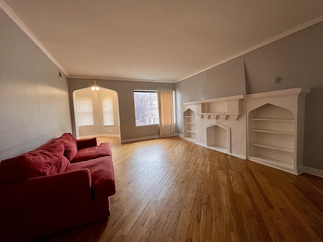 7628 S Essex Ave Unit 1N, Chicago, IL 60649 - living area with crown molding, wood finished floors, a fireplace, and arched walkways