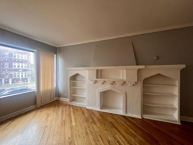 unfurnished living room featuring crown molding and wood-type flooring