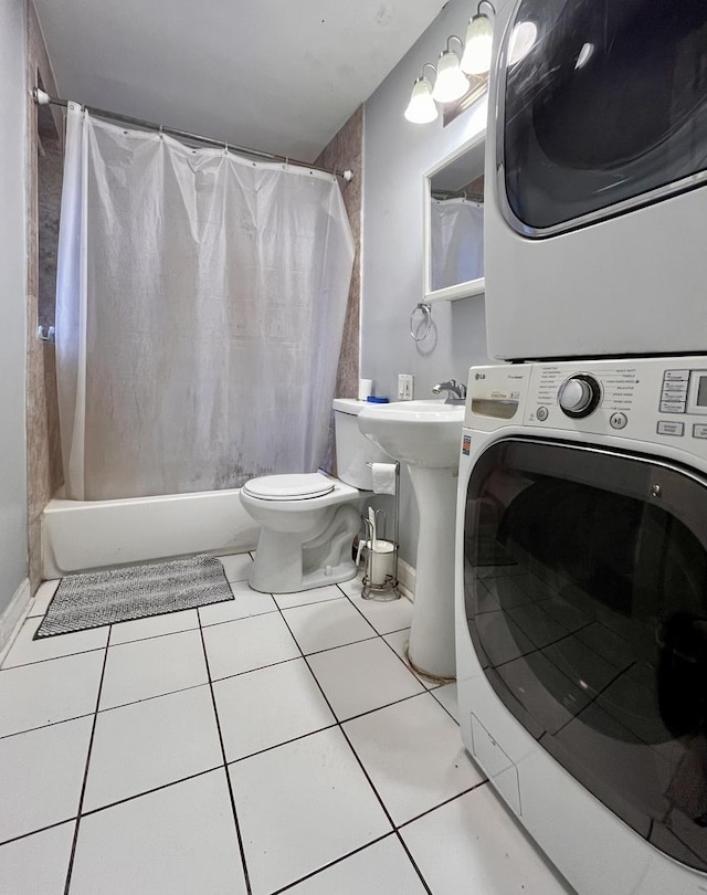 bathroom featuring tile patterned flooring, toilet, shower / bathtub combination with curtain, and stacked washer / drying machine