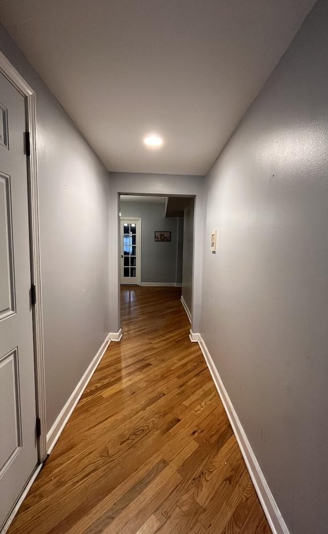 corridor featuring hardwood / wood-style floors