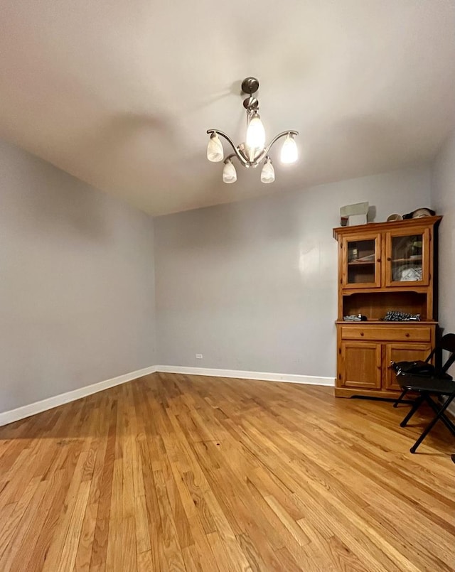 interior space with light hardwood / wood-style flooring and an inviting chandelier