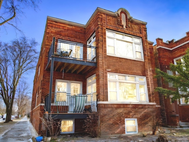 back of property with a porch and a balcony