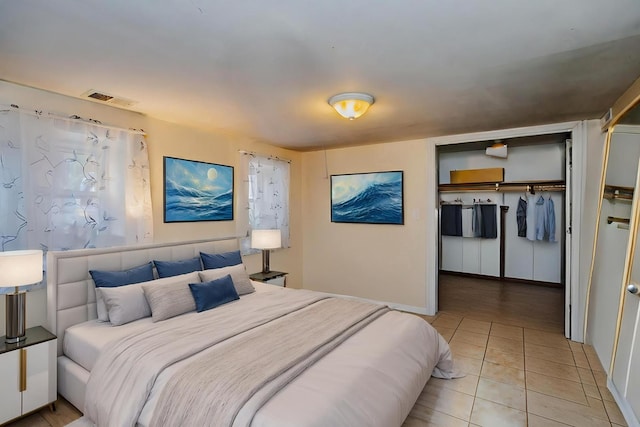 bedroom featuring a closet and light tile patterned flooring