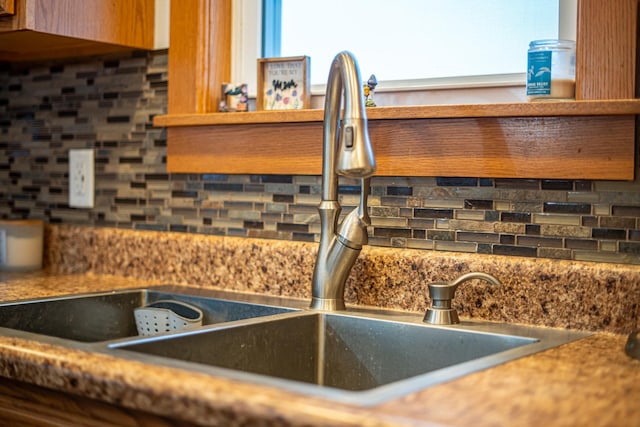 interior details featuring tasteful backsplash and sink