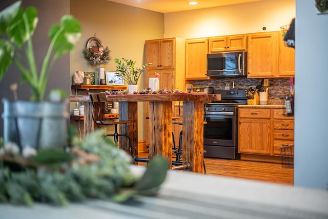 kitchen featuring backsplash and stainless steel electric range