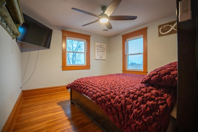 bedroom with ceiling fan and hardwood / wood-style flooring