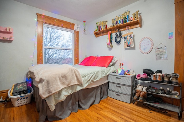 bedroom with hardwood / wood-style floors