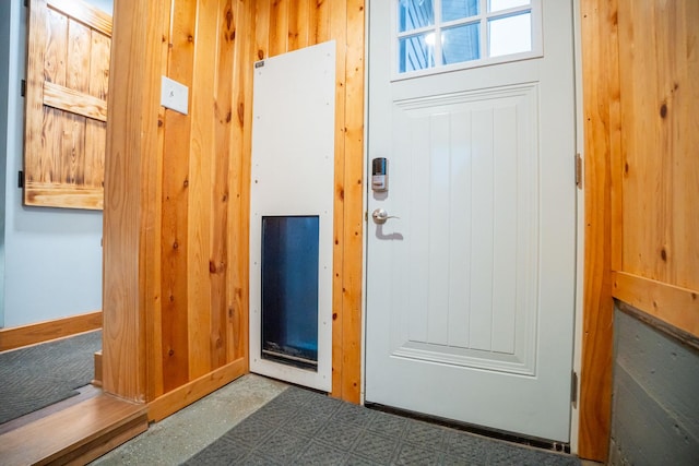 doorway with wood walls