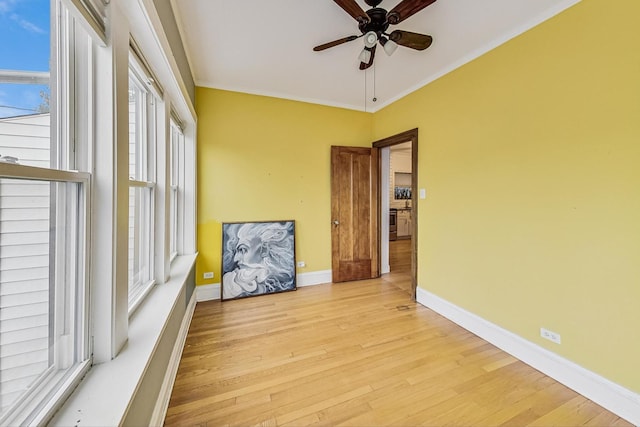 empty room featuring ornamental molding, ceiling fan, and light hardwood / wood-style floors