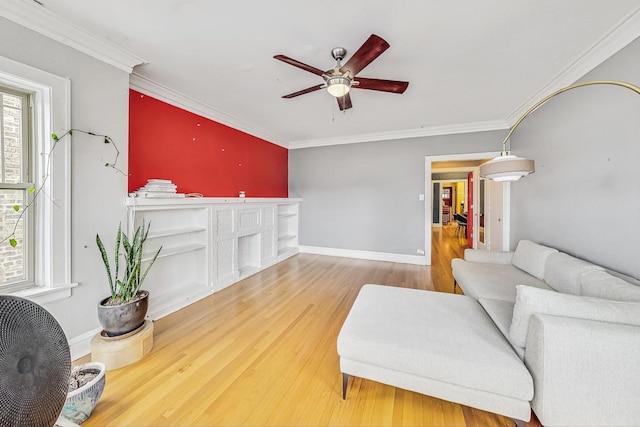 living room with ornamental molding, hardwood / wood-style floors, and ceiling fan