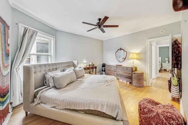 bedroom featuring ornamental molding, ceiling fan, and light wood-type flooring