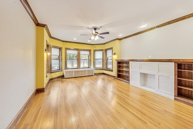 unfurnished living room with crown molding, a brick fireplace, light wood-type flooring, radiator heating unit, and ceiling fan