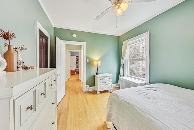 bedroom featuring crown molding, ceiling fan, and light hardwood / wood-style floors