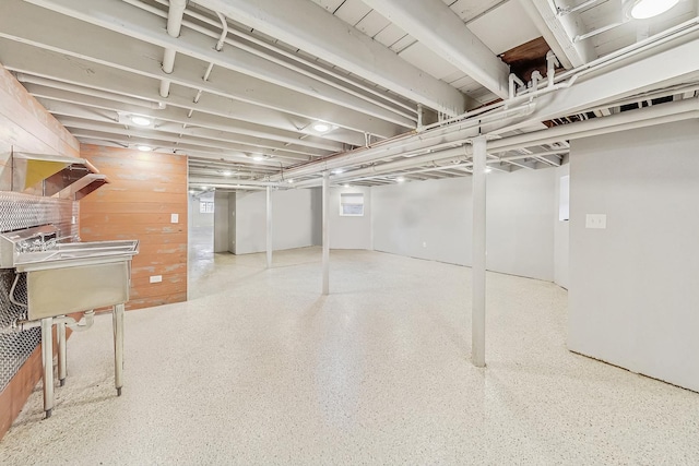 basement featuring wood walls