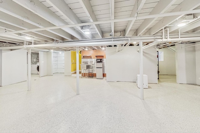 basement with separate washer and dryer and refrigerator