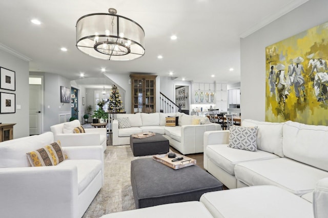 living room featuring ornamental molding and a chandelier