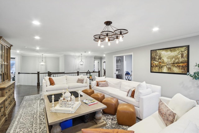 living room with a chandelier, ornamental molding, and dark hardwood / wood-style floors