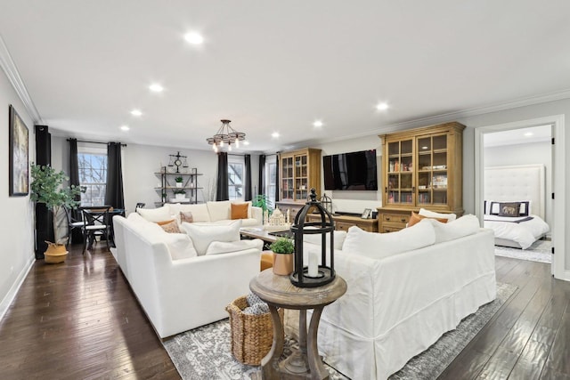 living room featuring dark hardwood / wood-style flooring, a wealth of natural light, and crown molding