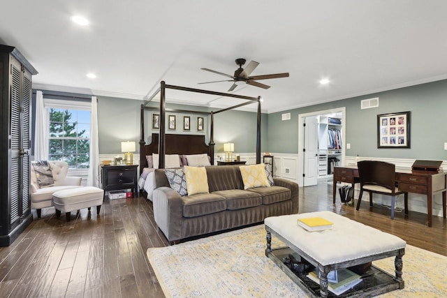 bedroom with a closet, ceiling fan, dark wood-type flooring, a spacious closet, and ornamental molding