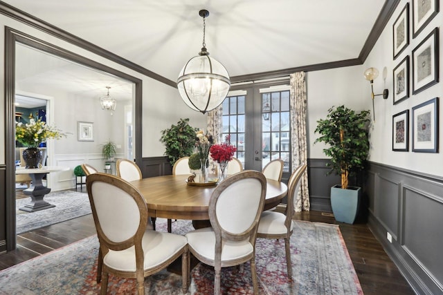 dining area with french doors, an inviting chandelier, crown molding, and dark hardwood / wood-style floors