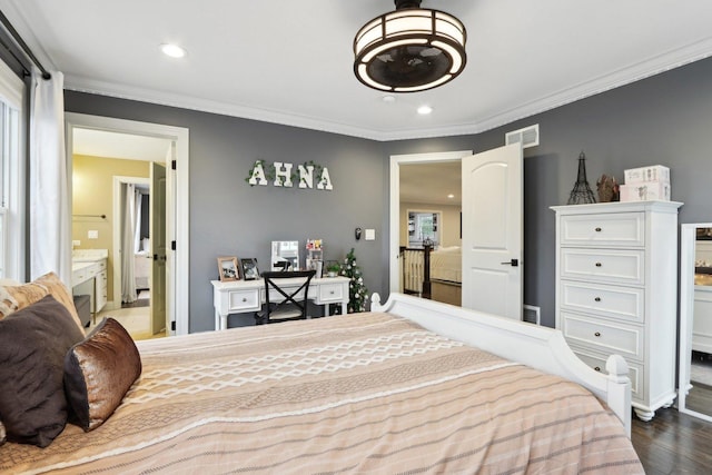 bedroom featuring hardwood / wood-style floors, connected bathroom, and ornamental molding