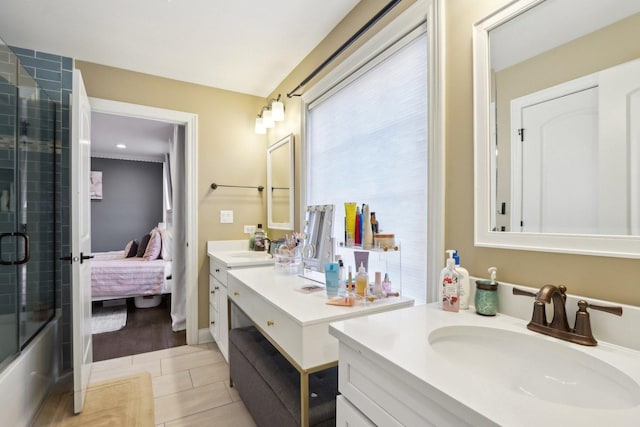 bathroom featuring vanity, shower / bath combination with glass door, and tile patterned floors