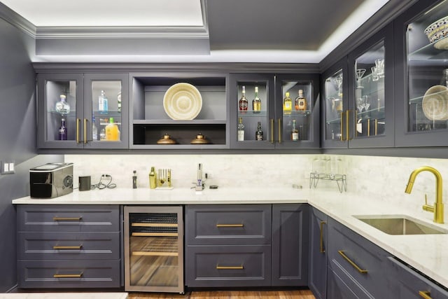 bar featuring wine cooler, light stone countertops, sink, black dishwasher, and tasteful backsplash