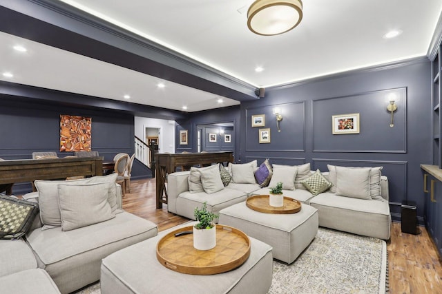 home theater featuring light wood-type flooring and crown molding