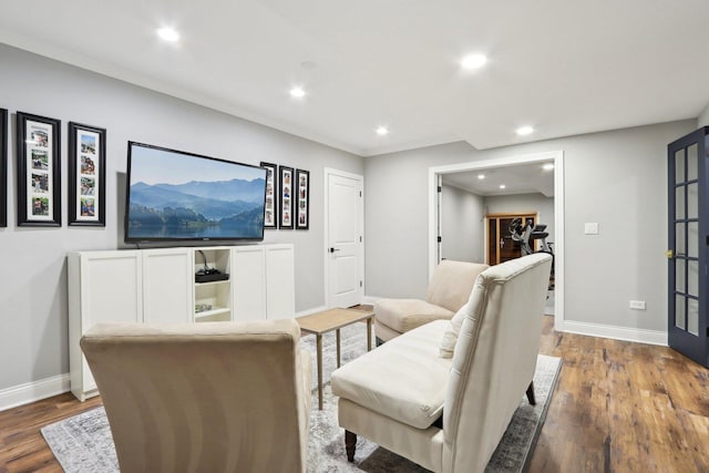 living room with ornamental molding and wood-type flooring