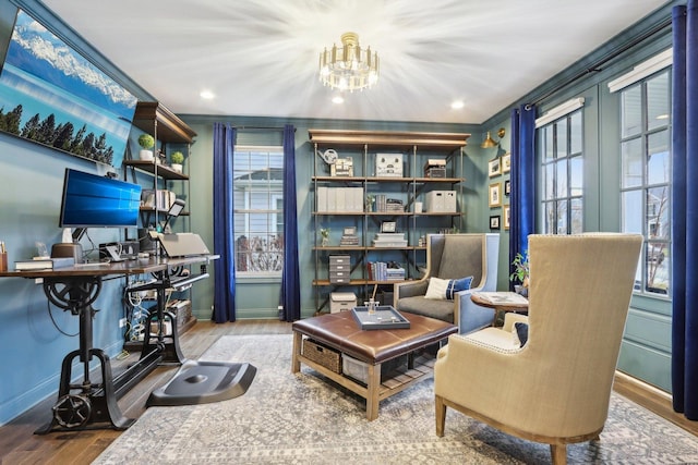 sitting room featuring an inviting chandelier, ornamental molding, and hardwood / wood-style floors