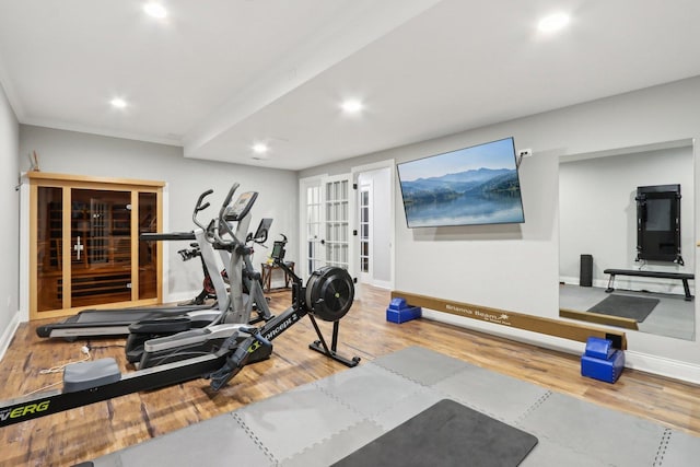 exercise area featuring crown molding